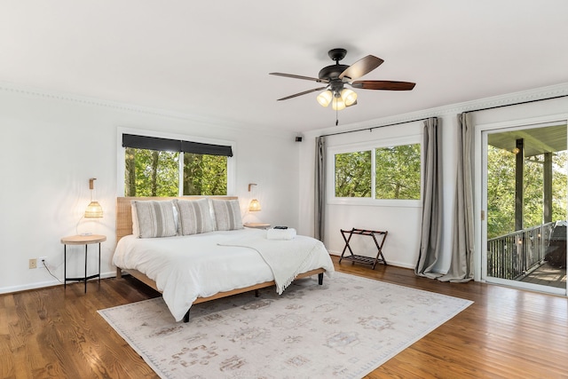 bedroom featuring ceiling fan, dark hardwood / wood-style floors, and access to exterior