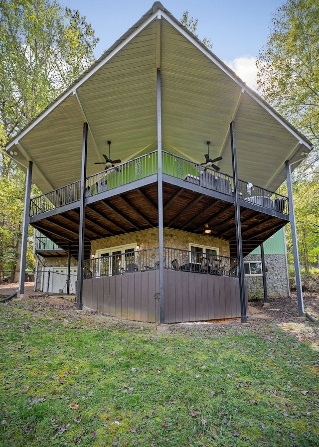 view of home's exterior with a yard, a wooden deck, and ceiling fan