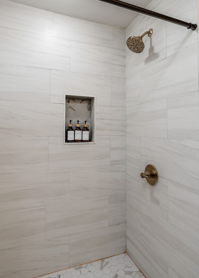 bathroom with a tile shower