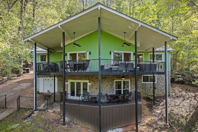 rear view of property with a wooden deck, ceiling fan, and a balcony