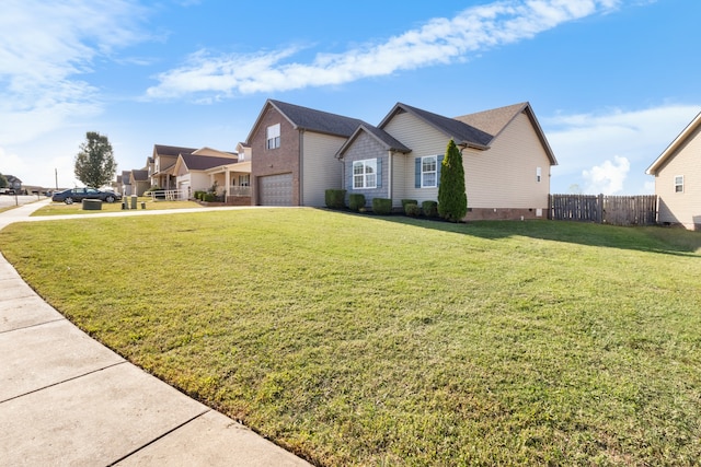 view of side of home featuring a garage and a yard