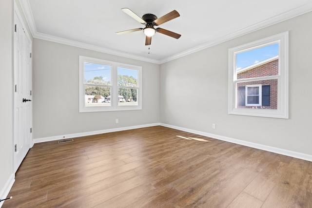 spare room featuring hardwood / wood-style flooring, crown molding, and ceiling fan