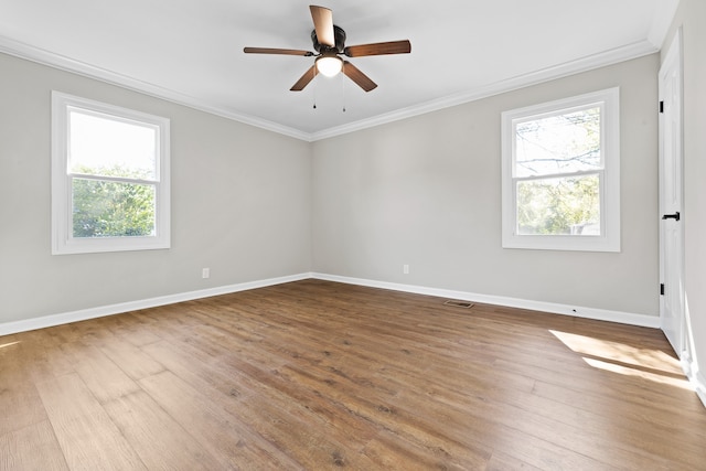 spare room with wood-type flooring, ornamental molding, and ceiling fan