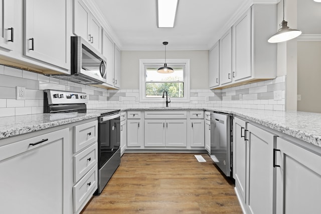 kitchen featuring white cabinets, stainless steel appliances, and sink