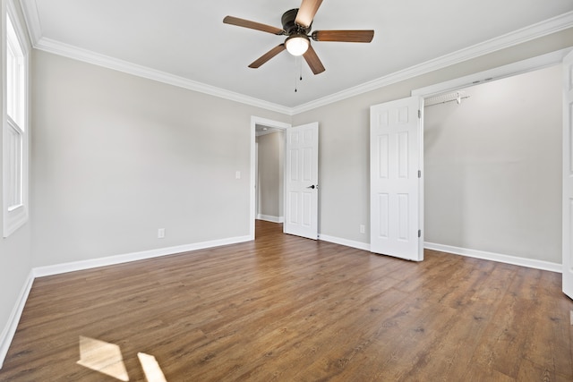 unfurnished bedroom with crown molding, dark hardwood / wood-style flooring, and ceiling fan