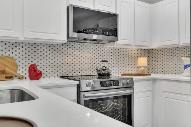 kitchen with appliances with stainless steel finishes and white cabinetry