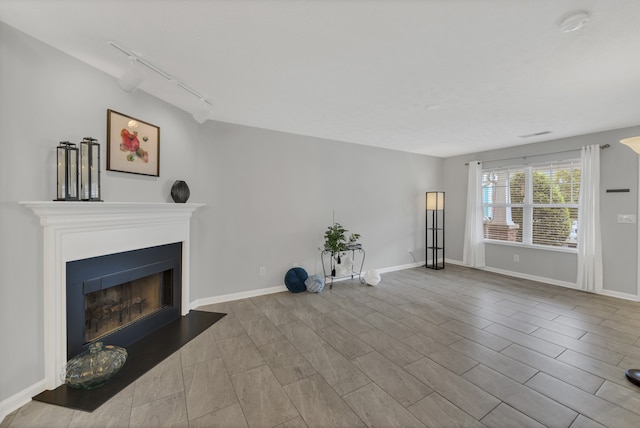 unfurnished living room with rail lighting