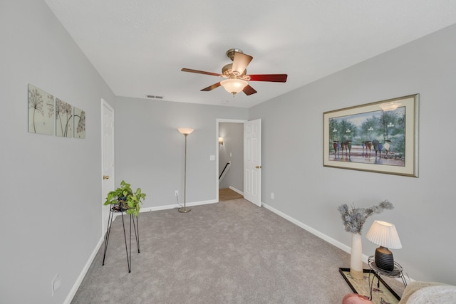 unfurnished room with ceiling fan and light colored carpet