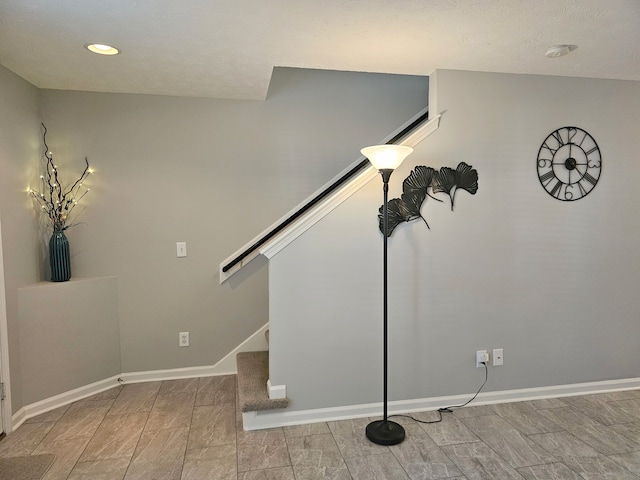 stairs with a textured ceiling