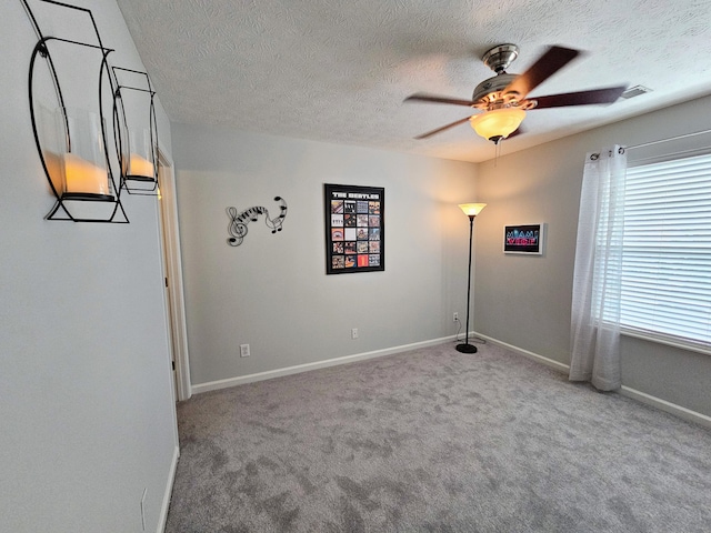 unfurnished room featuring carpet flooring, a textured ceiling, and ceiling fan