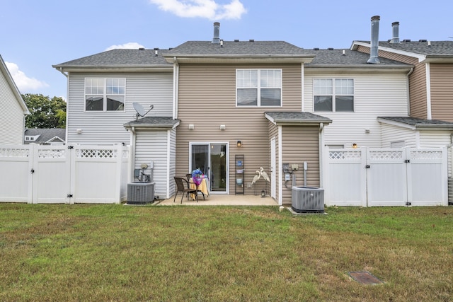 rear view of property with a lawn and a patio