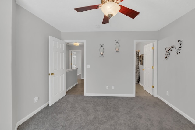 unfurnished bedroom with light carpet, a spacious closet, and ceiling fan