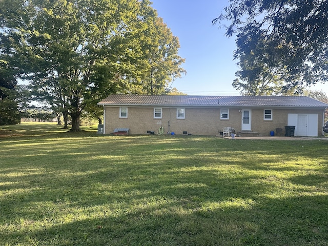 rear view of property with a lawn