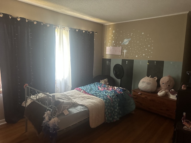 bedroom featuring hardwood / wood-style floors and a textured ceiling