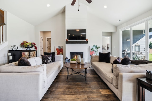 living room featuring dark wood-type flooring, ceiling fan, high vaulted ceiling, and a fireplace