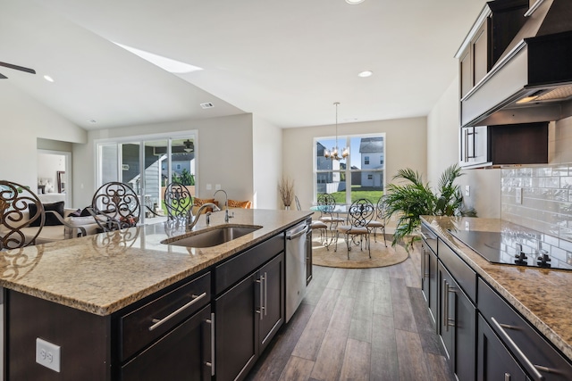 kitchen featuring a center island with sink, black electric cooktop, a wealth of natural light, and dark hardwood / wood-style flooring