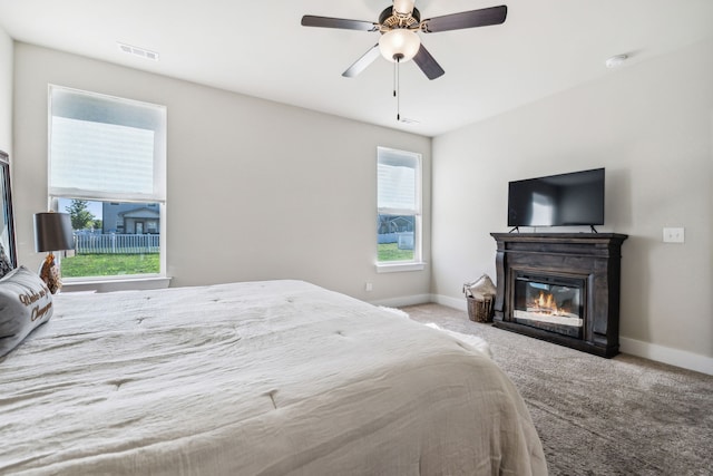 bedroom with ceiling fan and carpet floors