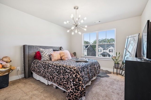 carpeted bedroom with a notable chandelier