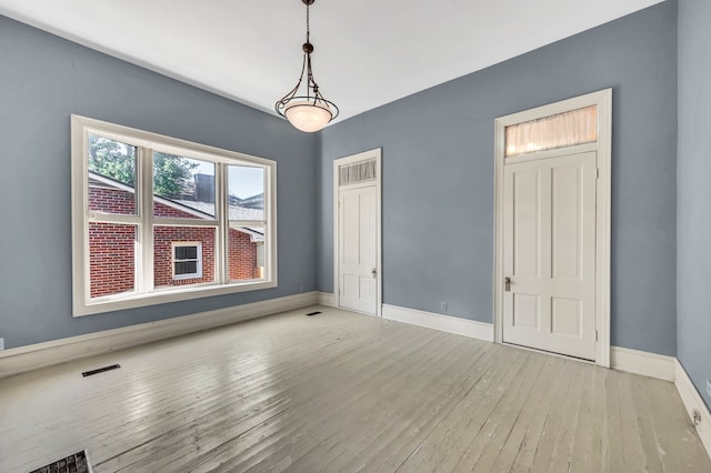 empty room with light hardwood / wood-style flooring