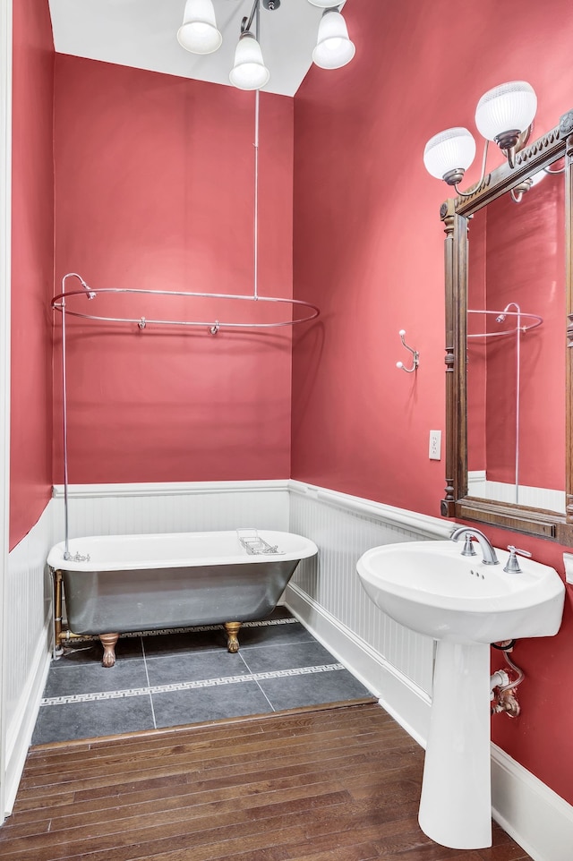 bathroom with hardwood / wood-style floors and a tub