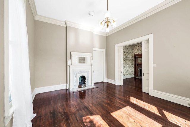 unfurnished living room featuring a fireplace, ornamental molding, an inviting chandelier, and dark hardwood / wood-style flooring