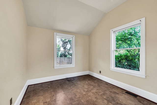 unfurnished room featuring lofted ceiling and carpet flooring