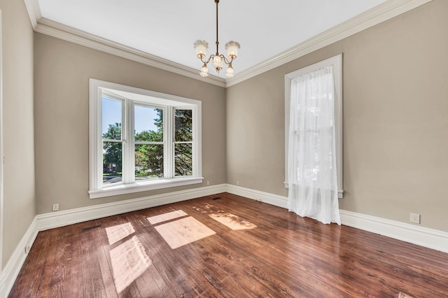 unfurnished room featuring ornamental molding, a notable chandelier, and dark wood-type flooring