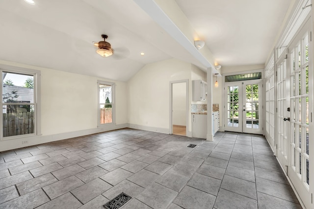 interior space with french doors, lofted ceiling, ceiling fan, and a healthy amount of sunlight