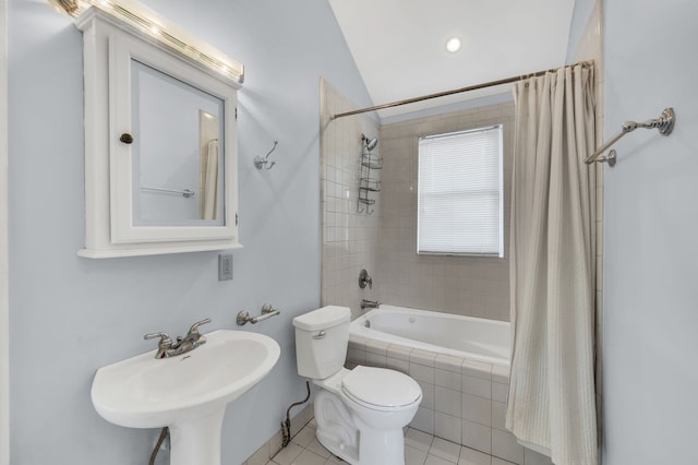 full bathroom featuring shower / tub combo with curtain, sink, tile patterned floors, vaulted ceiling, and toilet