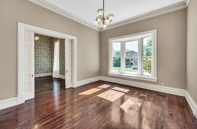 unfurnished room featuring ornamental molding, dark wood-type flooring, and an inviting chandelier