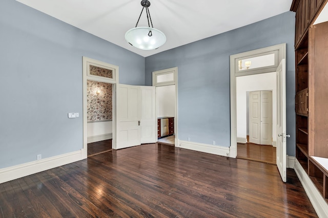 spare room with dark hardwood / wood-style flooring