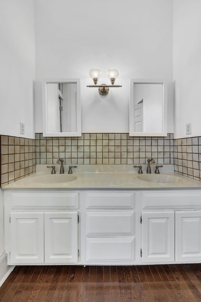 bathroom featuring vanity, hardwood / wood-style flooring, and tasteful backsplash