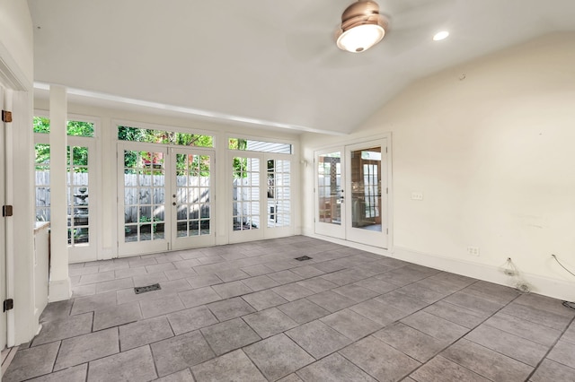 unfurnished room featuring french doors and vaulted ceiling