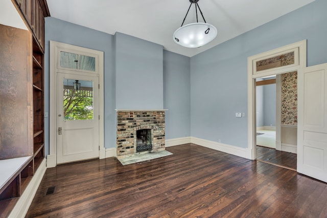 unfurnished living room featuring a fireplace and dark hardwood / wood-style flooring