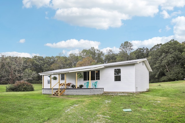 back of property featuring a yard