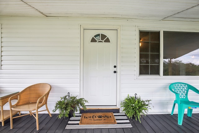 view of exterior entry with a wooden deck