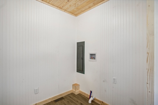 laundry room featuring electric panel, wood ceiling, wood walls, wood-type flooring, and hookup for a washing machine