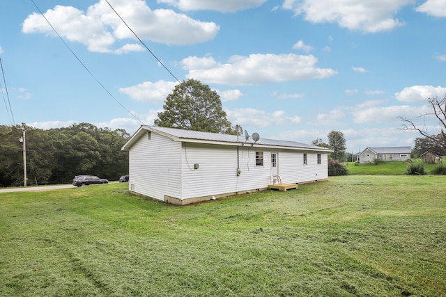 rear view of house with a lawn