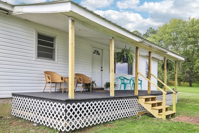 view of exterior entry with a yard