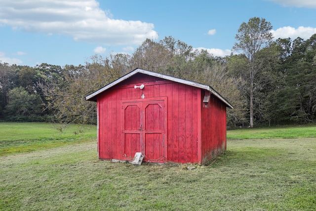 view of outbuilding with a lawn