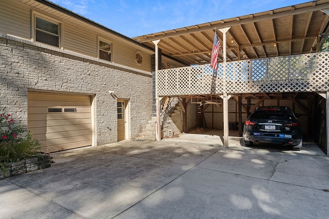 view of vehicle parking featuring a garage and a carport