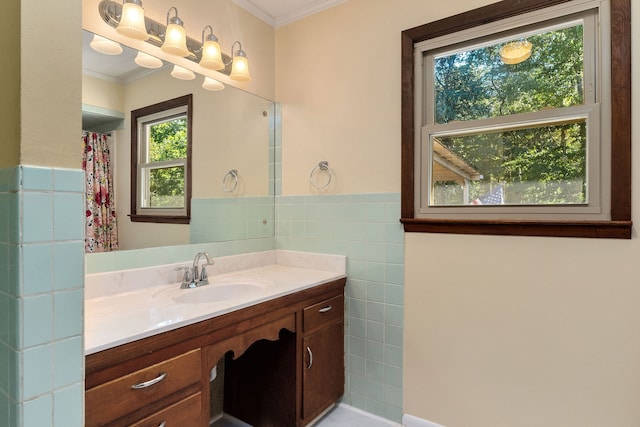 bathroom with a shower with curtain, vanity, tile walls, and ornamental molding