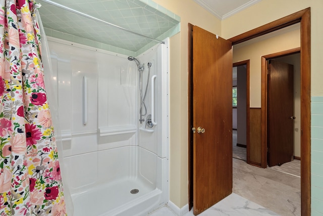 bathroom with ornamental molding and a shower with curtain