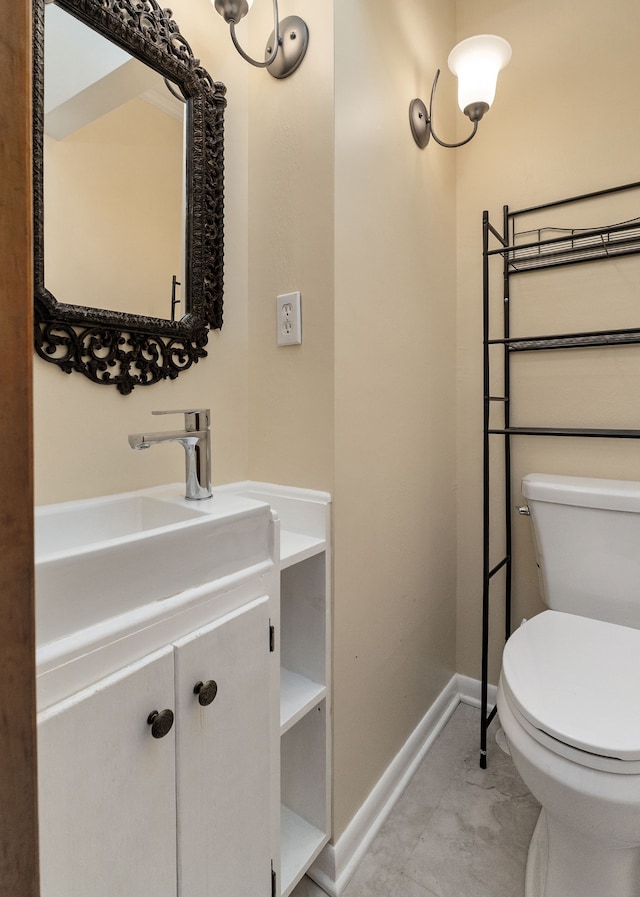 bathroom featuring tile patterned floors, vanity, and toilet