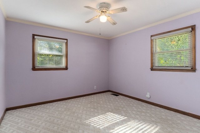 carpeted spare room with crown molding and ceiling fan