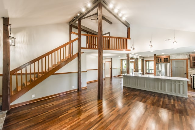 living room with sink, dark wood-type flooring, and high vaulted ceiling