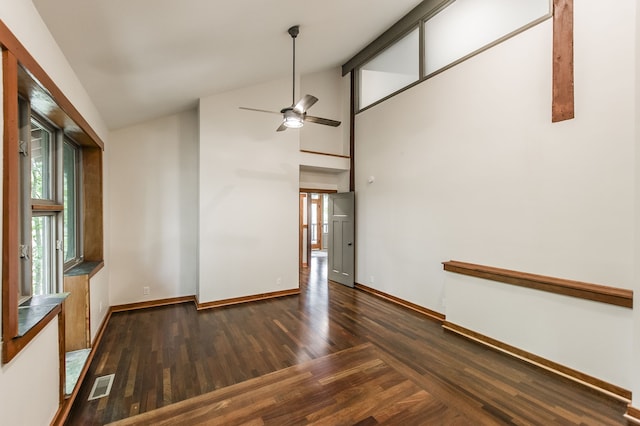 spare room featuring ceiling fan, dark hardwood / wood-style floors, and high vaulted ceiling