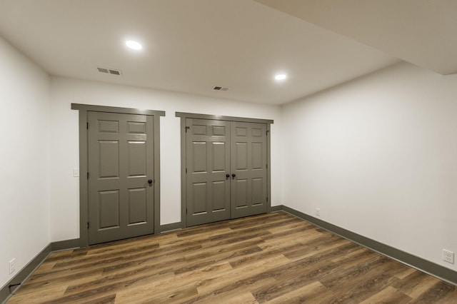interior space with recessed lighting, baseboards, visible vents, and dark wood-type flooring