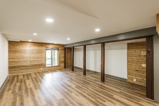 below grade area featuring baseboards, recessed lighting, and wood finished floors