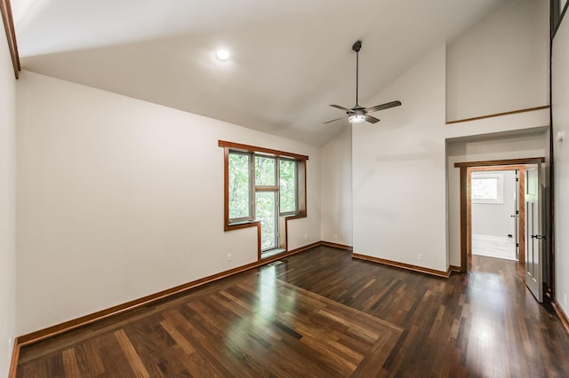empty room featuring a ceiling fan, baseboards, dark wood finished floors, and high vaulted ceiling